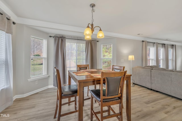 dining room with an inviting chandelier, light wood-style flooring, and baseboards