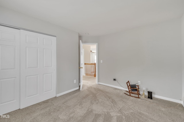 unfurnished bedroom with carpet floors, baseboards, and a closet