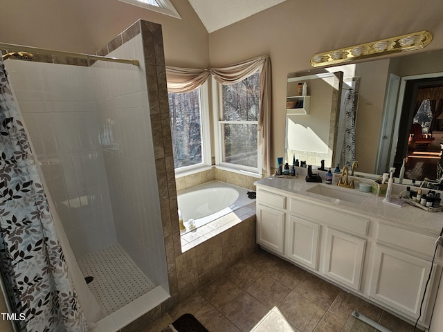 full bath featuring vaulted ceiling, a bath, a tile shower, and a wealth of natural light