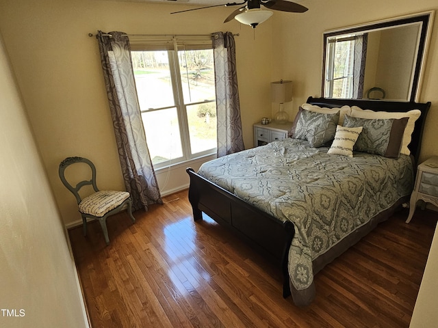 bedroom with ceiling fan, baseboards, and wood finished floors