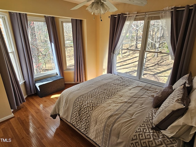 bedroom with a ceiling fan and wood-type flooring