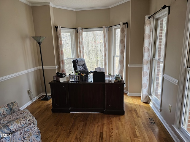 office area featuring visible vents, baseboards, plenty of natural light, and light wood finished floors