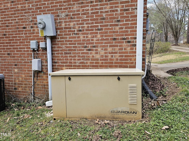 exterior details with brick siding, a power unit, and electric meter