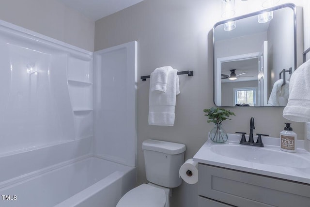 bathroom featuring toilet, shower / bath combination, and vanity