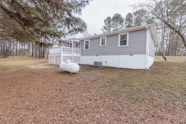 view of front of home featuring a deck, crawl space, and cooling unit