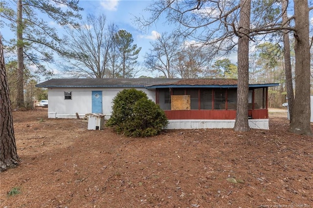 back of house featuring a sunroom