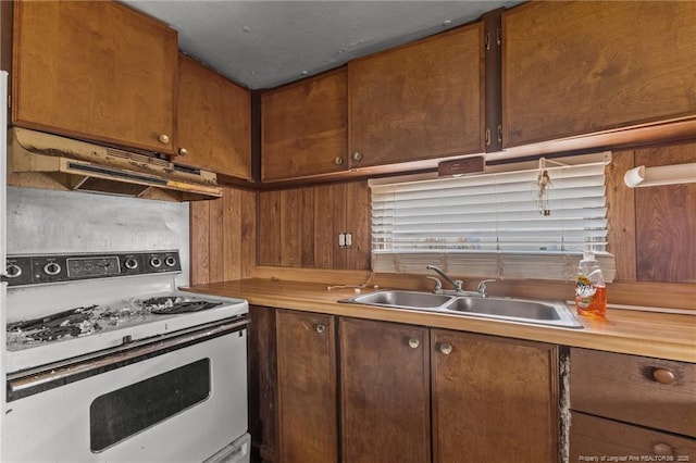 kitchen featuring light countertops, a sink, under cabinet range hood, and white electric range oven