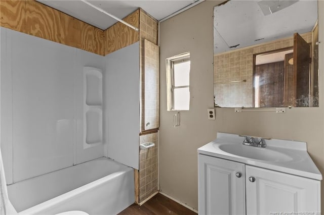 full bathroom featuring  shower combination, vanity, and wood finished floors