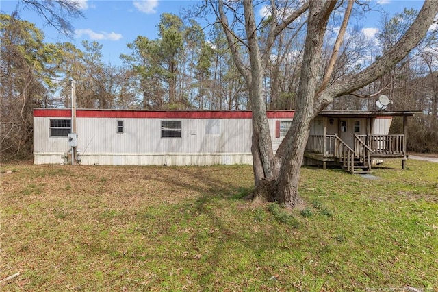 view of side of home with a yard