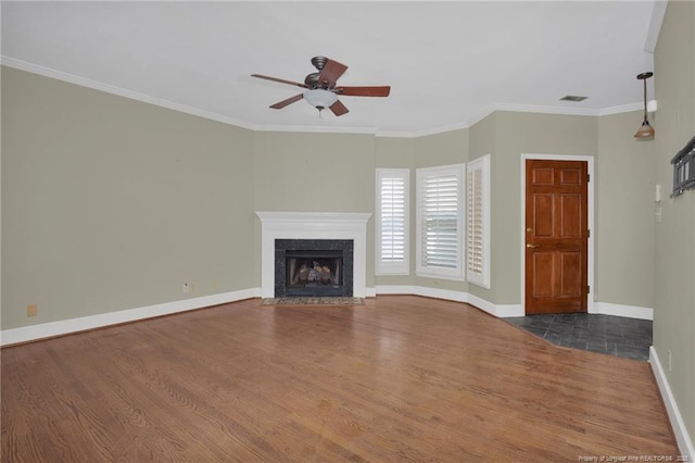 unfurnished living room with crown molding, a premium fireplace, and dark wood-type flooring