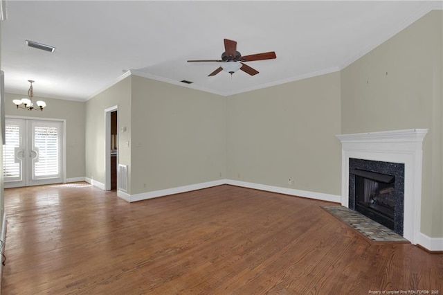 unfurnished living room featuring ornamental molding, a high end fireplace, baseboards, and wood finished floors