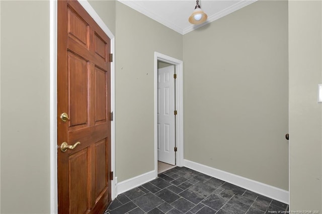 entryway featuring crown molding, stone finish flooring, and baseboards