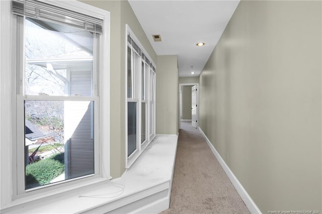 corridor with baseboards, visible vents, carpet flooring, and recessed lighting