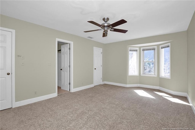 unfurnished bedroom featuring carpet, visible vents, and baseboards