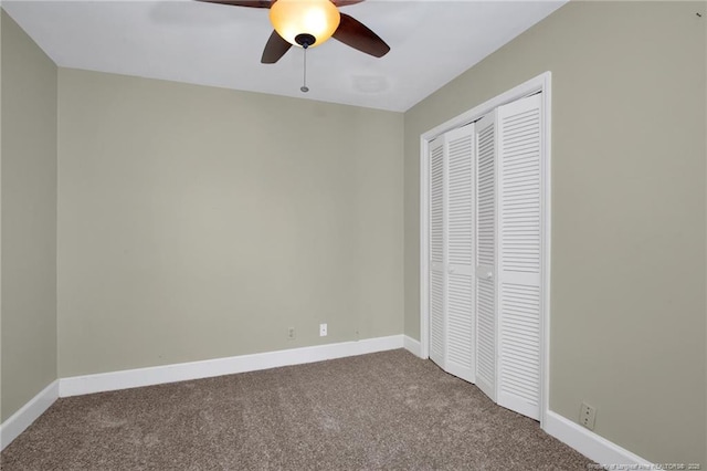 unfurnished bedroom with carpet, baseboards, ceiling fan, and a closet