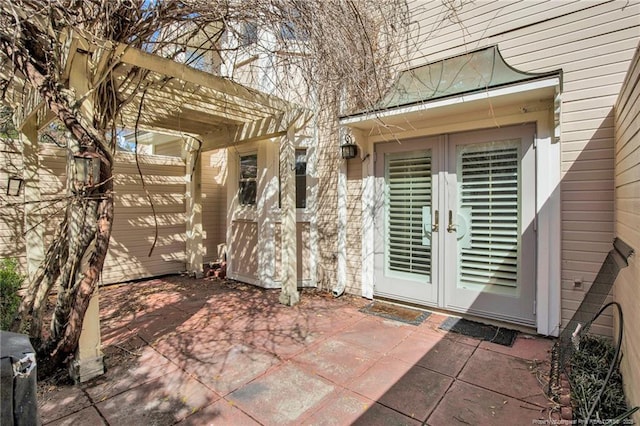 doorway to property featuring french doors, a patio area, and a pergola