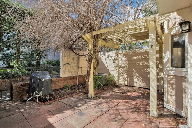 view of patio with fence, grilling area, and a pergola