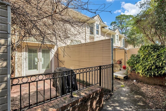 view of side of property featuring french doors