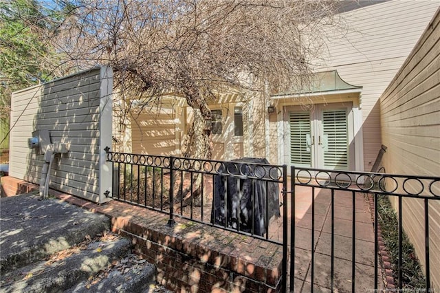 doorway to property featuring a gate and fence