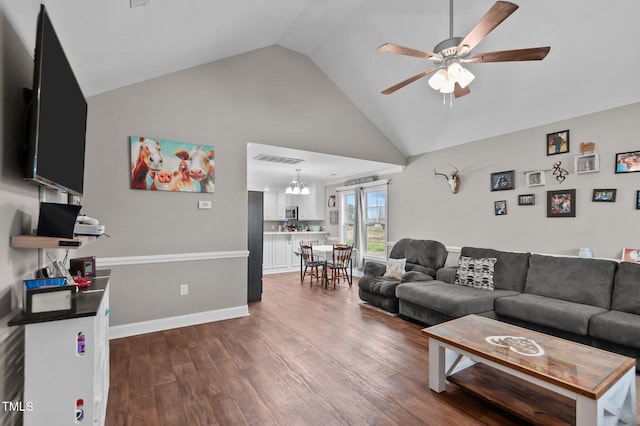 living room with baseboards, visible vents, ceiling fan, dark wood-type flooring, and high vaulted ceiling