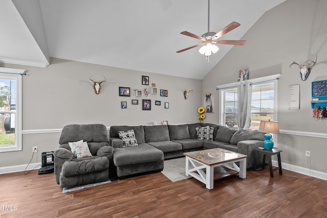 living room with plenty of natural light, high vaulted ceiling, and wood finished floors