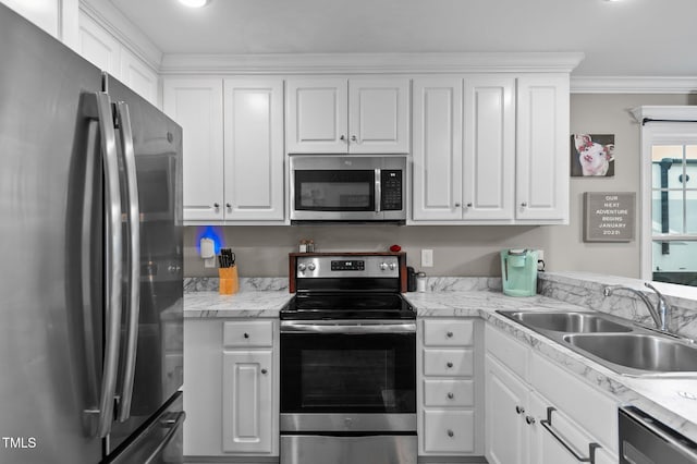 kitchen featuring stainless steel appliances, white cabinetry, and a sink