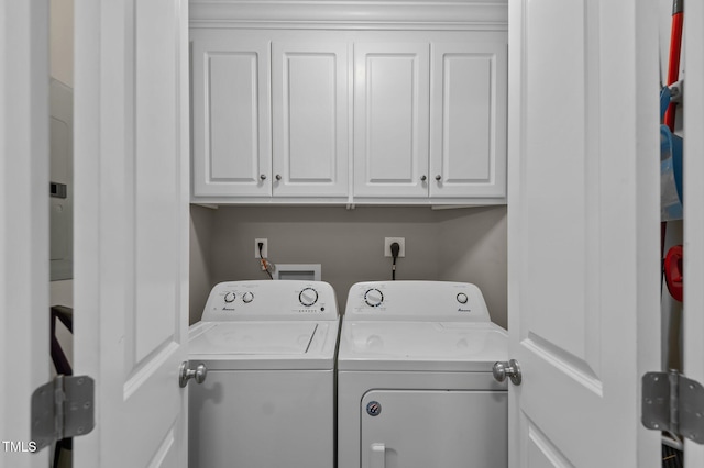 laundry area featuring cabinet space and washing machine and clothes dryer