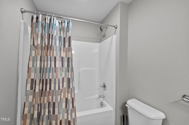 bathroom featuring shower / bath combo and toilet