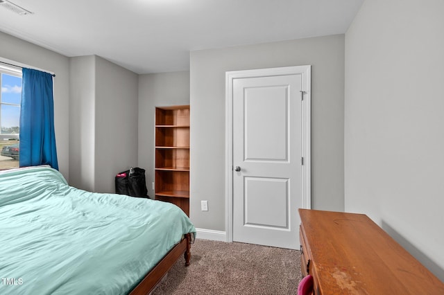 carpeted bedroom featuring baseboards and visible vents