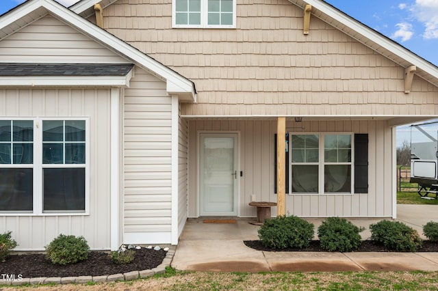 view of front of property with a porch and roof with shingles