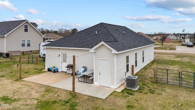 rear view of house featuring a shingled roof, a patio area, fence, and a gate