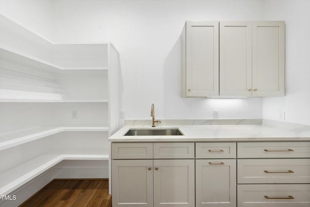 kitchen with dark wood-style floors, open shelves, and a sink