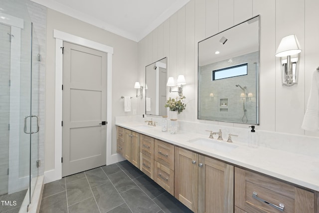 bathroom featuring double vanity, ornamental molding, a stall shower, and a sink