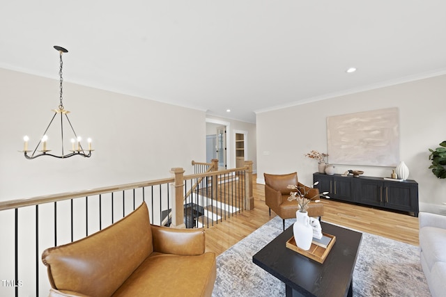 living area with ornamental molding, recessed lighting, an inviting chandelier, and wood finished floors