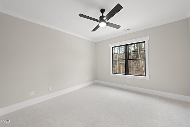 unfurnished room with ornamental molding, light colored carpet, visible vents, and baseboards