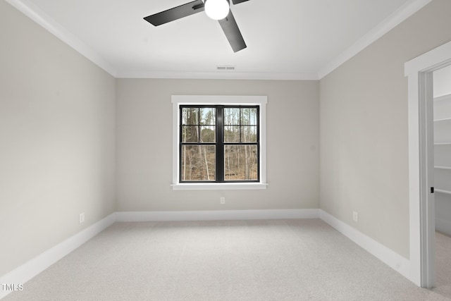 unfurnished room featuring ornamental molding, carpet, visible vents, and baseboards