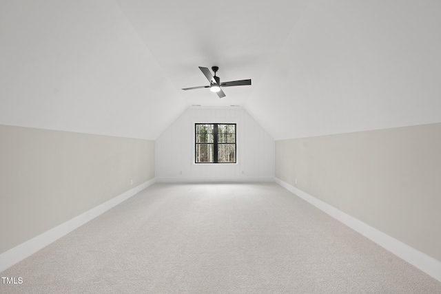 additional living space with a ceiling fan, lofted ceiling, light carpet, and baseboards