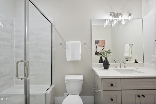 bathroom with a stall shower, vanity, and toilet