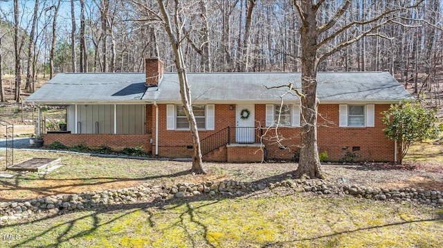 single story home with a front yard, brick siding, a chimney, and crawl space