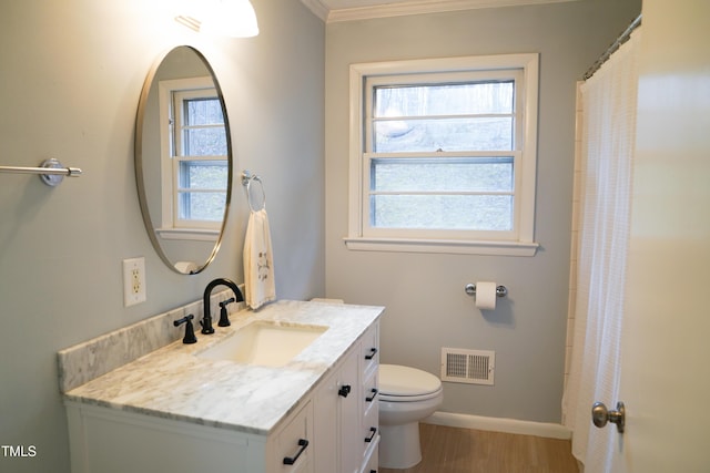 full bathroom featuring visible vents, a healthy amount of sunlight, toilet, and vanity