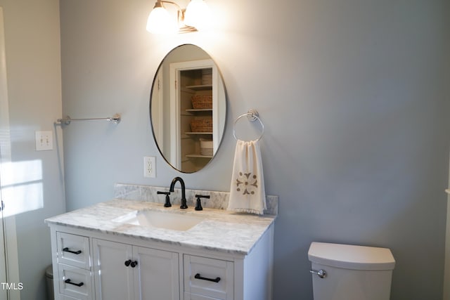 half bathroom featuring toilet and vanity