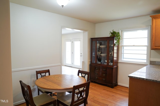 dining space featuring light wood finished floors