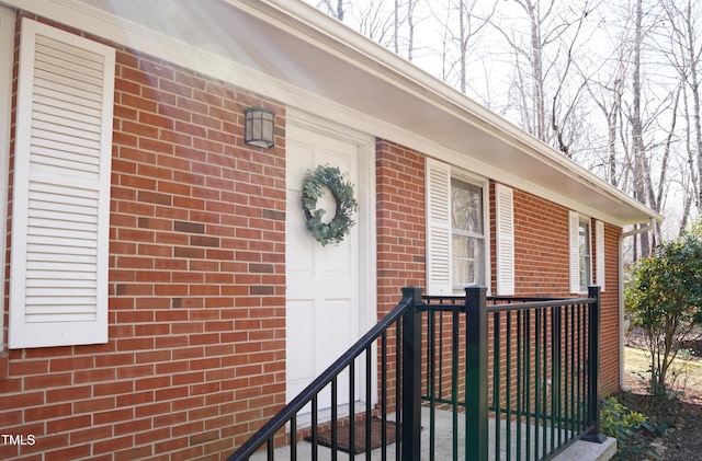 entrance to property featuring brick siding