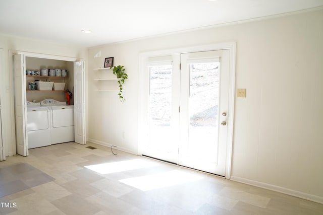 laundry room featuring laundry area, light floors, independent washer and dryer, and baseboards