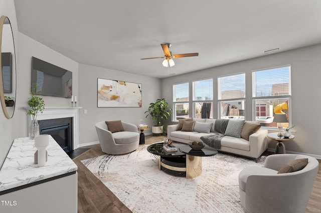 717 Tailrace Falls Ct, Wake Forest, NC 27587 - living room with a ceiling fan, dark wood-type flooring, a glass covered fireplace, and baseboards