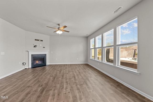 717 Tailrace Falls Ct, Wake Forest, NC 27587 - unfurnished living room with a ceiling fan, wood finished floors, a fireplace with flush hearth, and baseboards