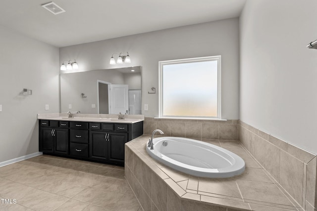 717 Tailrace Falls Ct, Wake Forest, NC 27587 - bathroom with double vanity, a garden tub, and tile patterned floors