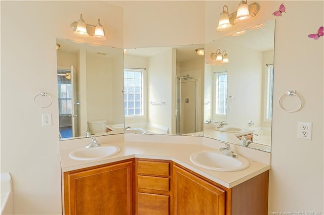 full bathroom with plenty of natural light, a sink, and a bath