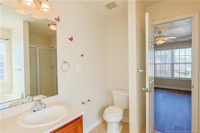 full bathroom with visible vents, toilet, ceiling fan, a shower stall, and vanity