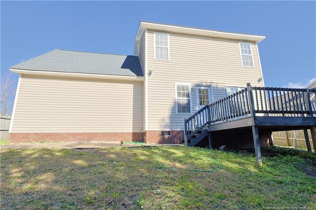 rear view of house featuring a deck, a yard, crawl space, and stairs